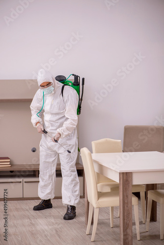 Young male contractor doing pest control at home © Elnur
