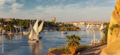 Beautiful panorama landscape with felucca boats on Nile river in Aswan at sunset, Egypt