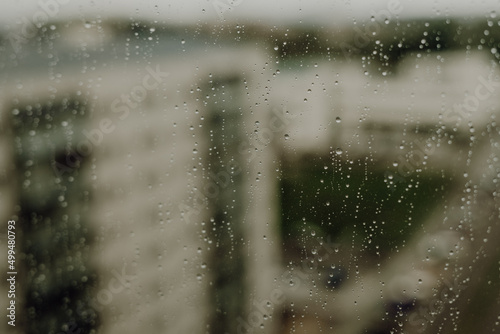 Raindrops on a window against some buildings
