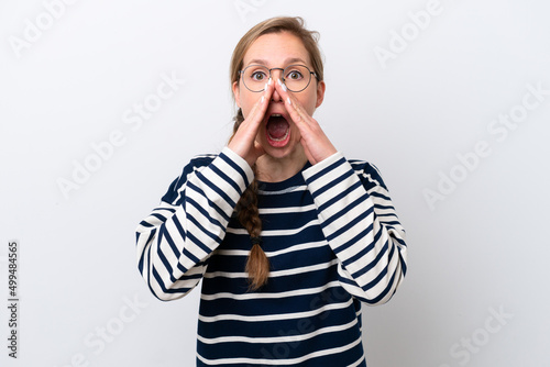 Young caucasian woman isolated on white background shouting and announcing something