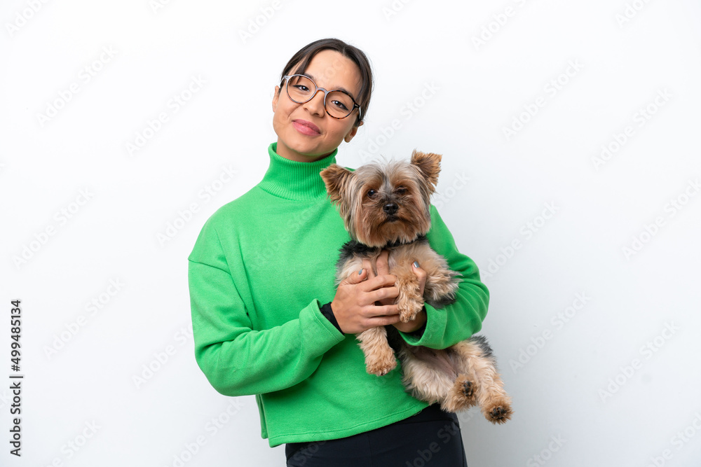 Young hispanic woman holding a dog isolated on white background with happy expression Young hispanic woman holding a dog isolated on white background with happy expression