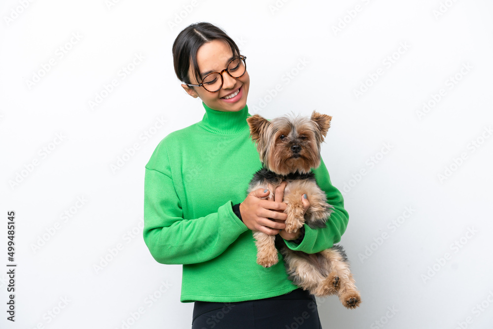 Young hispanic woman holding a dog isolated on white background with happy expression Young hispanic woman holding a dog isolated on white background with happy expression