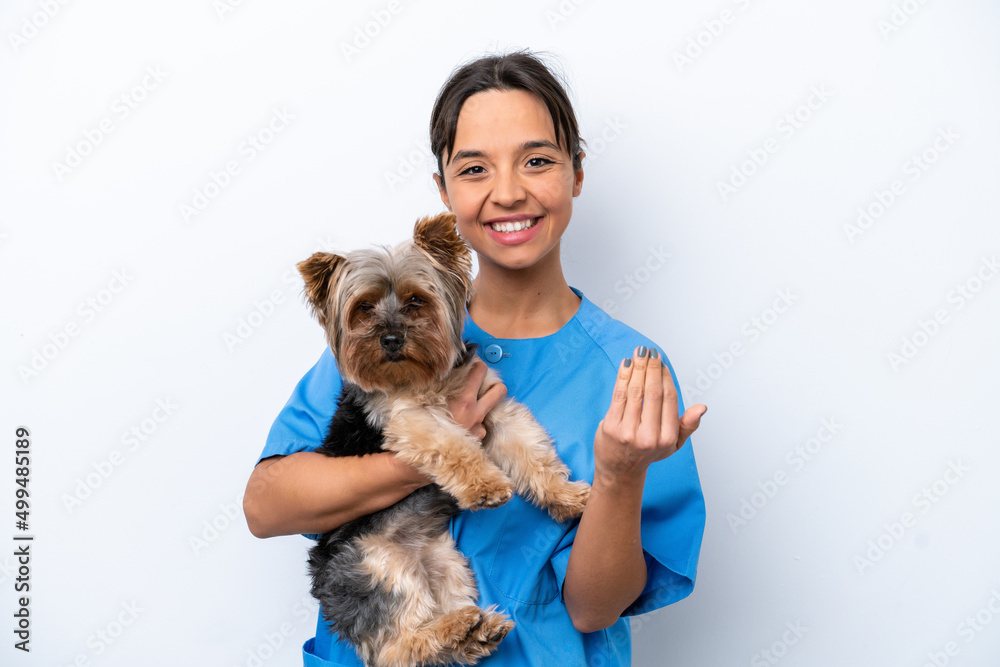 Young veterinarian woman with dog isolated on white background inviting to come with hand. Happy that you came Young veterinarian woman with dog isolated on white background inviting to come with hand. Happy that you came