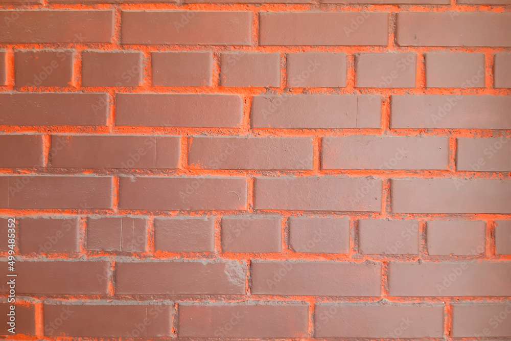 Obraz premium Brick wall background. Bright brown-orange.