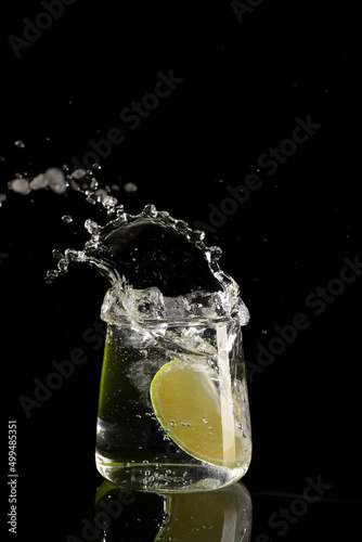 mojito cocktail on a black background with reflection