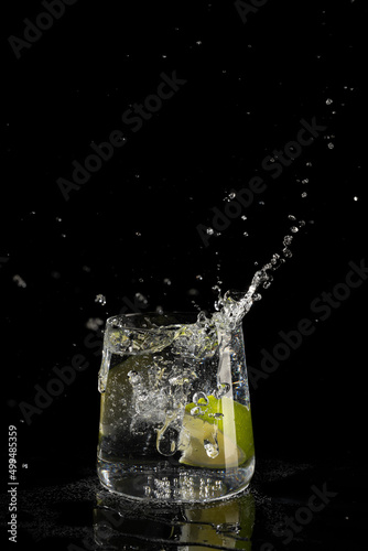 mojito cocktail on a black background with reflection
