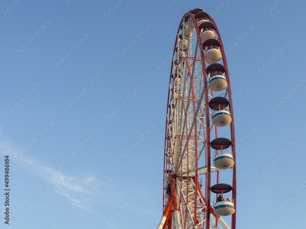 Ferris wheel against the sky. Amusement park on the sea. Rest zone. Ferris wheel. Ferris wheel against the sky. Amusement park on the sea. Rest zone. Ferris wheel.