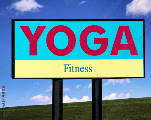 Bright yoga and fitness sign against a sky and horizon background.