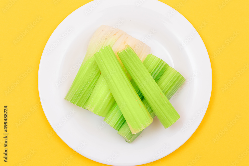 Fresh Chopped Celery Sticks on White Dish. Vegan and Vegetarian Culture. Raw Food. Healthy Diet with Negative Calorie Content Fresh Chopped Celery Sticks on White Dish. Vegan and Vegetarian Culture. Raw Food. Healthy Diet with Negative Calorie Content