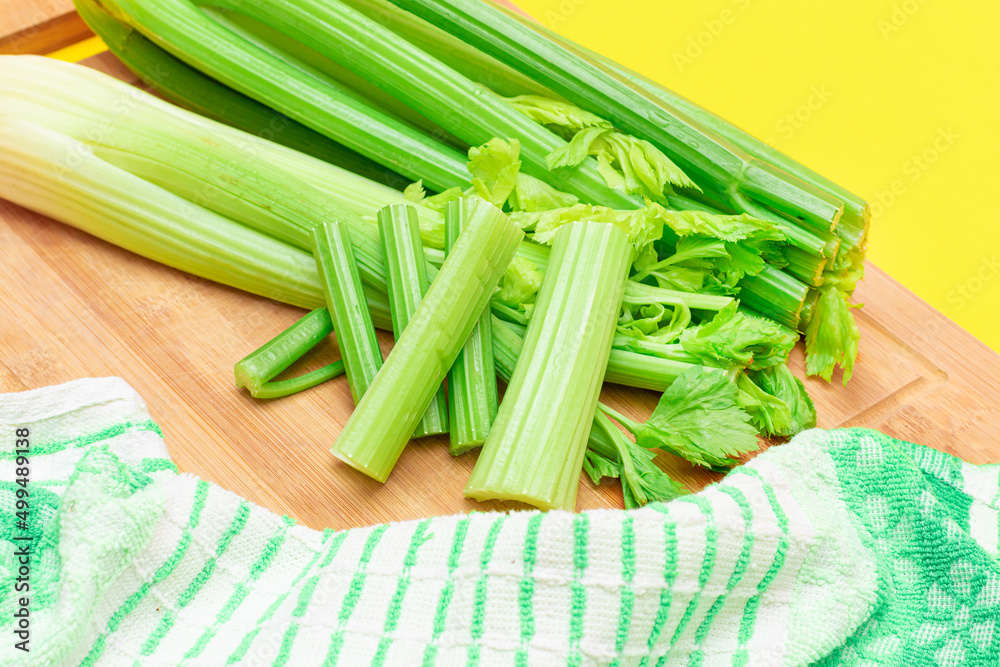 Fresh Celery Stem and Chopped Celery Sticks on Wooden Cutting Board. Vegan and Vegetarian Culture. Raw Food. Healthy Diet with Negative Calorie Content. Slimming Food Fresh Celery Stem and Chopped Celery Sticks on Wooden Cutting Board. Vegan and Vegetarian Culture. Raw Food. Healthy Diet with Negative Calorie Content. Slimming Food