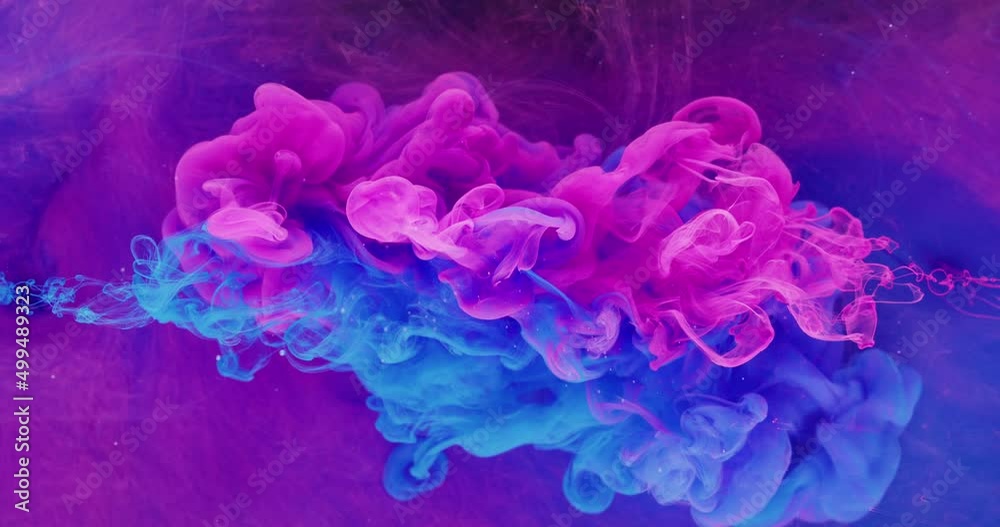 Color fluid mix. Smoke cloud motion. Logo opener effect. Neon pink blue ink drop on bright purple fog texture abstract background shot on Red Cinema camera 6k.