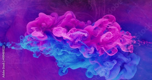 Color fluid mix. Smoke cloud motion. Logo opener effect. Neon pink blue ink drop on bright purple fog texture abstract background shot on Red Cinema camera 6k.