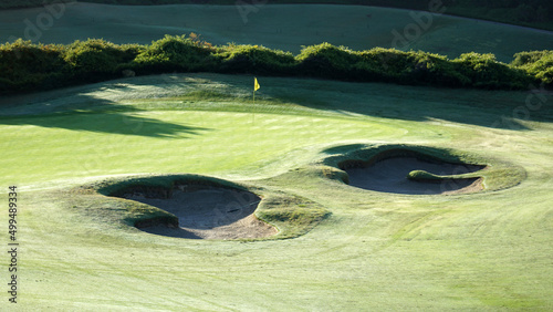 Overlooking the 15th hole of a golf course in morning light. photo