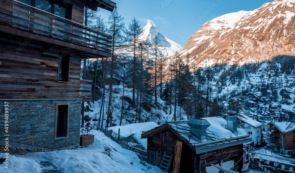 Scenic view of ski resort in town overlooking Matterhorn mountain during winter