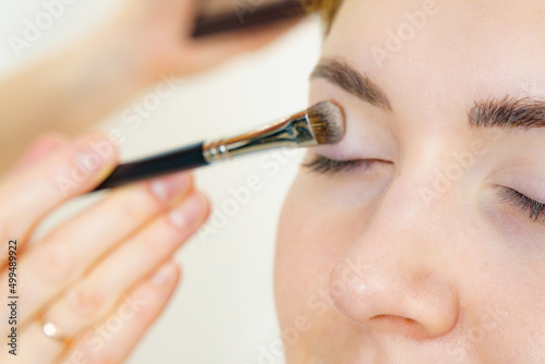 Makeup artist applying eye make up