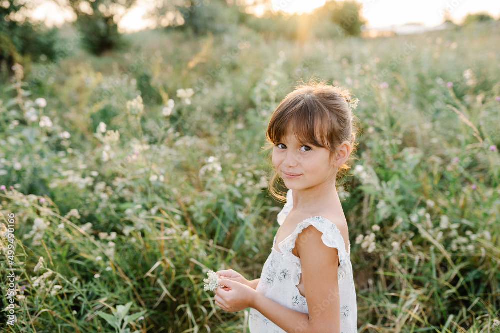 Happy little girl in the field of Queen Anne's Lace flower Happy little girl in the field of Queen Anne's Lace flower