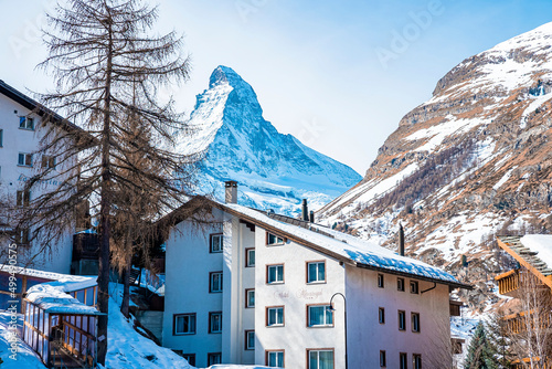 View of snow covered town and Matterhorn mountain against sky during winter