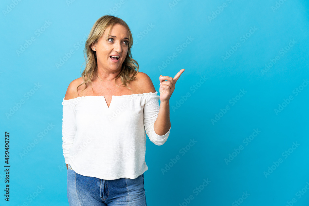 Middle aged blonde woman over isolated background intending to realizes the solution while lifting a finger up Middle aged blonde woman over isolated background intending to realizes the solution while lifting a finger up