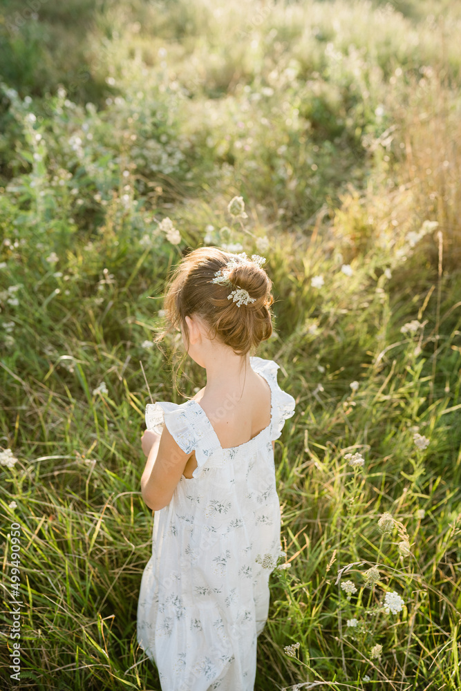 Happy little girl in the field of Queen Anne's Lace flower Happy little girl in the field of Queen Anne's Lace flower