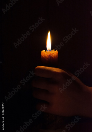 burning candle in his hand, a prayer in the church. The Christian.