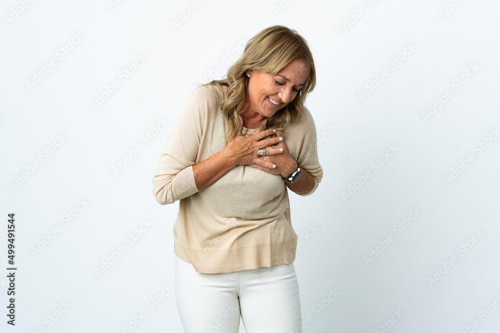 Middle aged blonde woman over isolated white background having a pain in the heart Middle aged blonde woman over isolated white background having a pain in the heart
