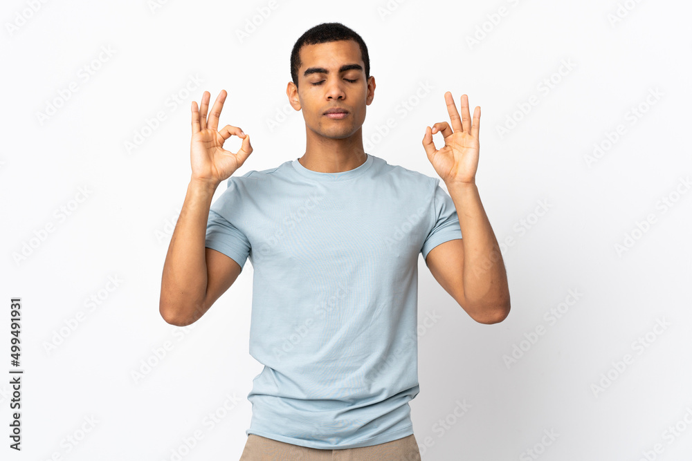 African American man over isolated white background in zen pose African American man over isolated white background in zen pose
