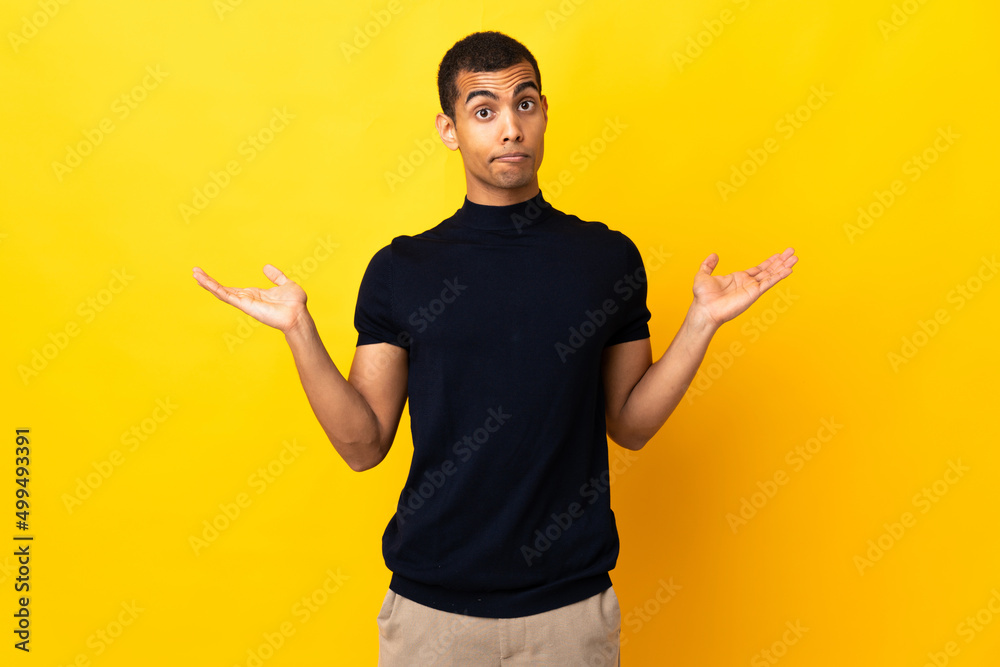 African American man over isolated background having doubts while raising hands African American man over isolated background having doubts while raising hands