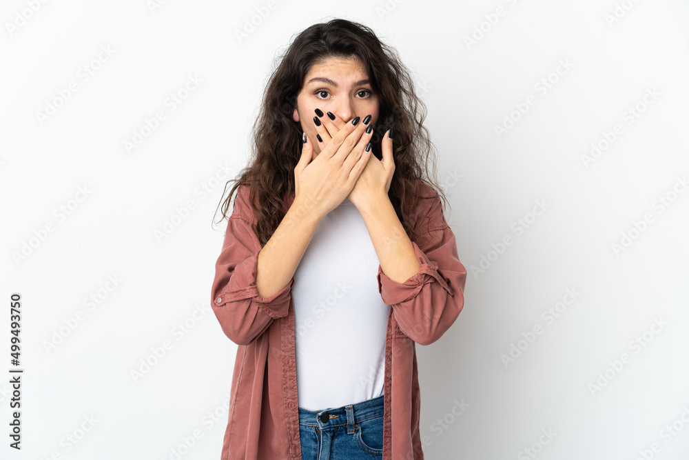 Teenager Russian girl isolated on white background covering mouth with hands Teenager Russian girl isolated on white background covering mouth with hands