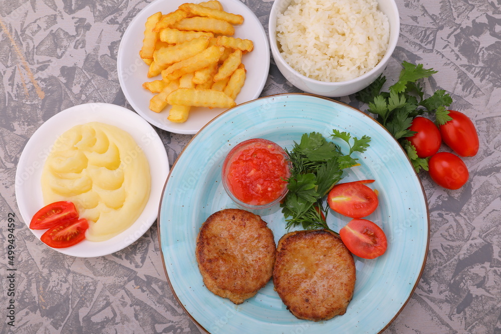 cutlet with sauce and side dish of potatoes rice mashed potatoes with vegetables photo dishes for the menu of restaurants and cafes cutlet with sauce and side dish of potatoes rice mashed potatoes with vegetables photo dishes for the menu of restaurants and cafes