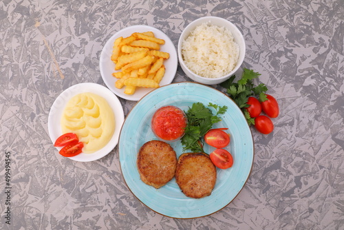 cutlet with sauce and side dish of potatoes rice mashed potatoes with vegetables photo dishes for the menu of restaurants and cafes