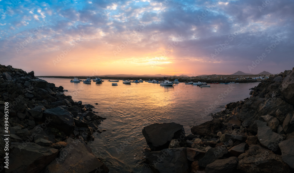 Sunrise on the beach with rocks and warm colors on the Canary Island of Fuerteventura