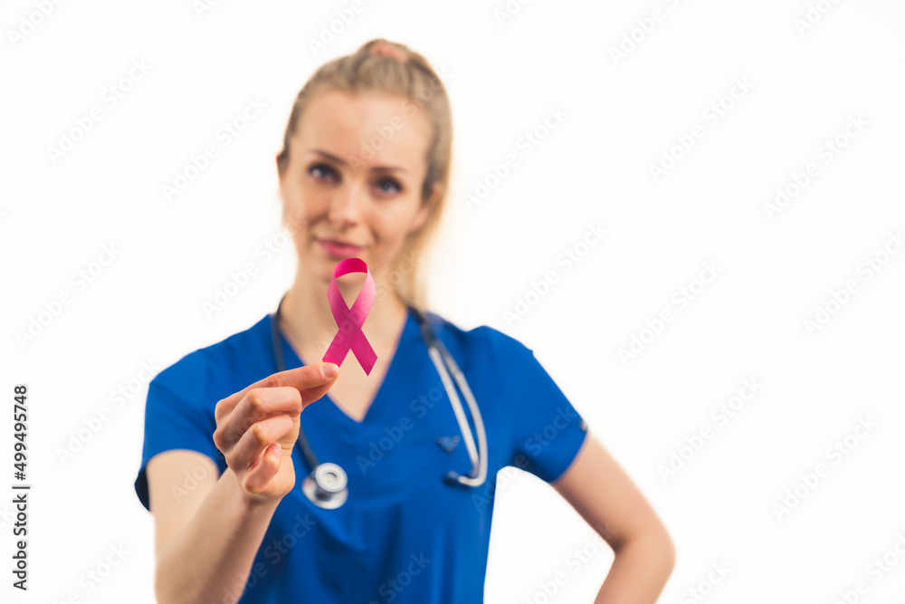 nurse holding a pink ribbon - an International Symbol of Breast Cancer Awareness Month in October health care and medical concept medium closeup white background . High quality photo nurse holding a pink ribbon - an International Symbol of Breast Cancer Awareness Month in October health care and medical concept medium closeup white background . High quality photo