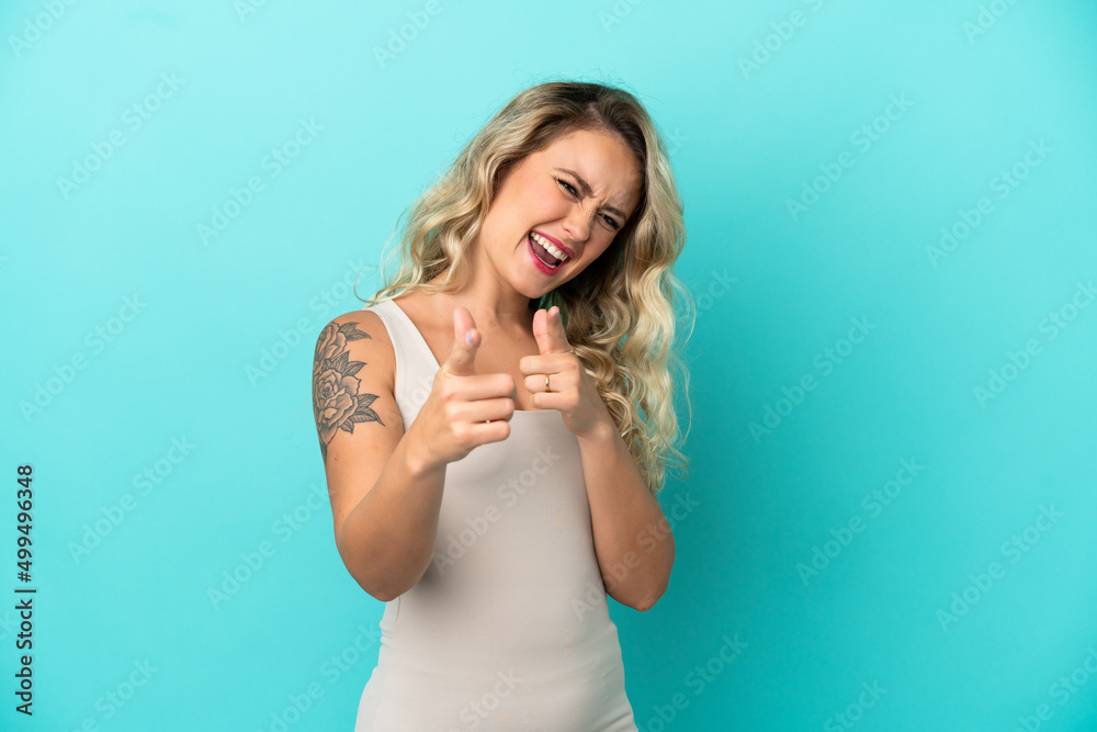Young Brazilian woman isolated on blue background pointing to the front and smiling Young Brazilian woman isolated on blue background pointing to the front and smiling