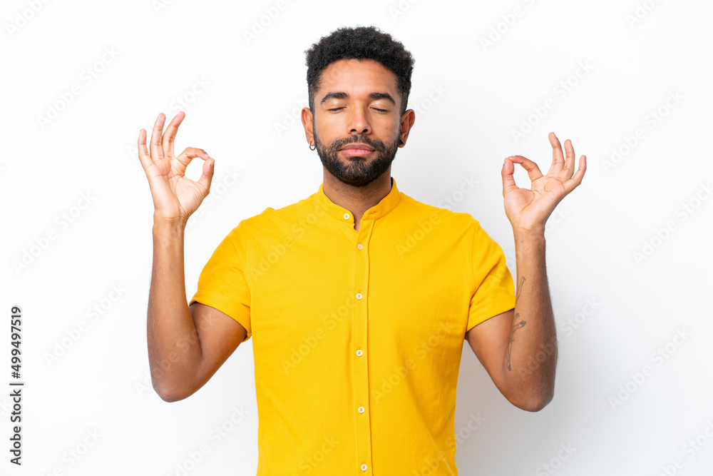 Young Brazilian man isolated on white background in zen pose Young Brazilian man isolated on white background in zen pose