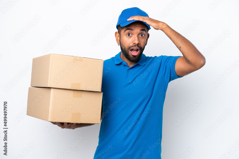 Delivery Brazilian man isolated on white background with surprise expression Delivery Brazilian man isolated on white background with surprise expression