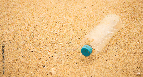 Tablou pe pânză pet bottle thrown on the beach sand