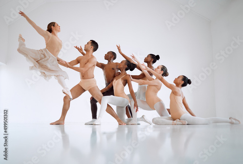 It requires training to attain perfection in this dance form. Shot of a group of ballet dancers practicing a routine in a dance studio.