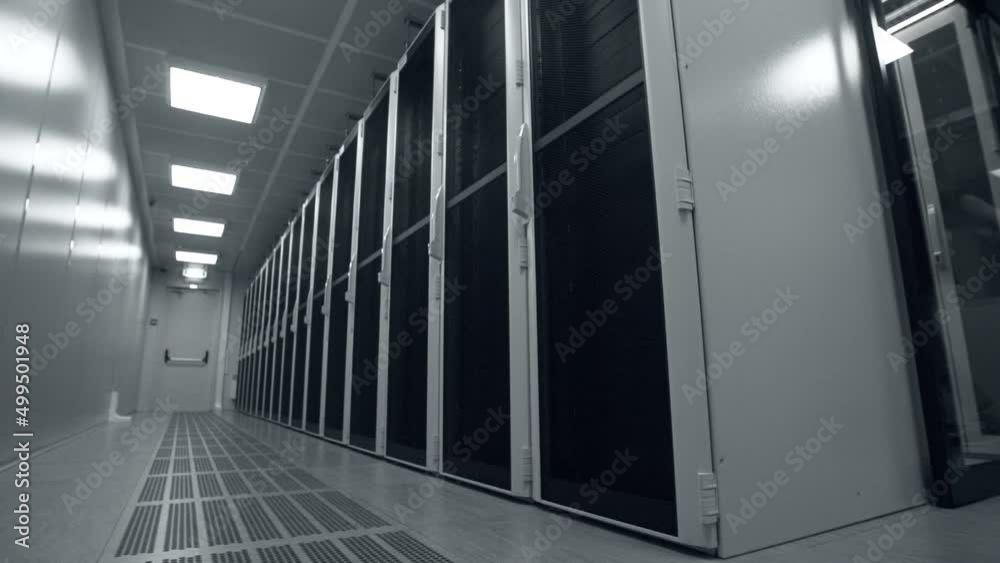 Shot of Corridor in Working Data Center Full of Rack Servers and Supercomputers.