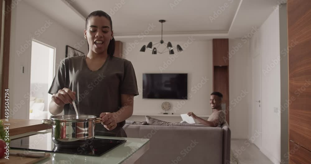 Couple cooking and working from home Couple cooking and working from home