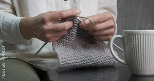 Relaxing on sofa with yarn. A view of relaxing female with yarn and mug of tea during winter weekend.