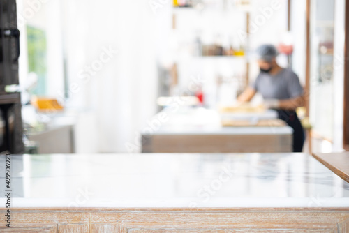 Selective focus and blurred background of beautiful bright and white decorative kitchen with people or chef is working to prepare delicious meal, food and bakery for lunch or dinner.