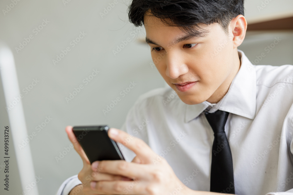 close up asian business person looking down at cellphone operating in office.. close up asian business person looking down at cellphone operating in office..
