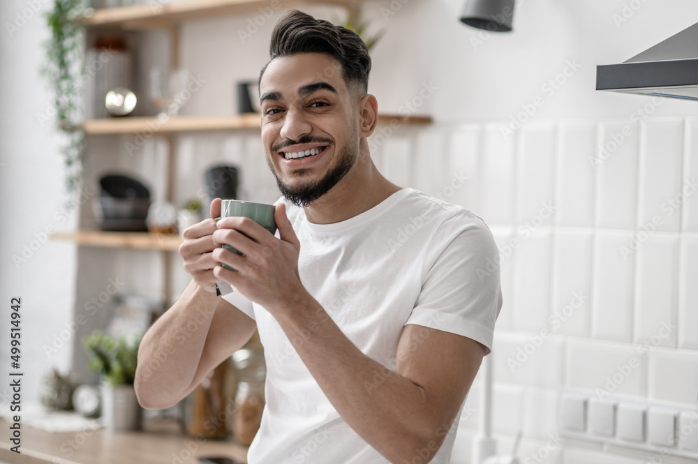 A smiling man having coffee in the morning A smiling man having coffee in the morning