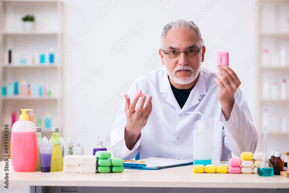 Old male chemist testing soap in the lab Old male chemist testing soap in the lab