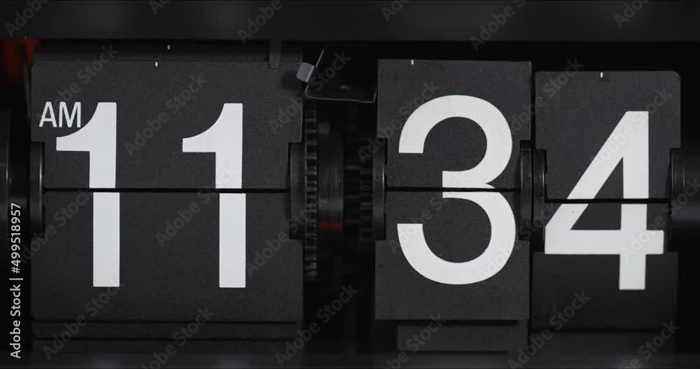 Classic flip clock on black background from 11.34, Time concept. 