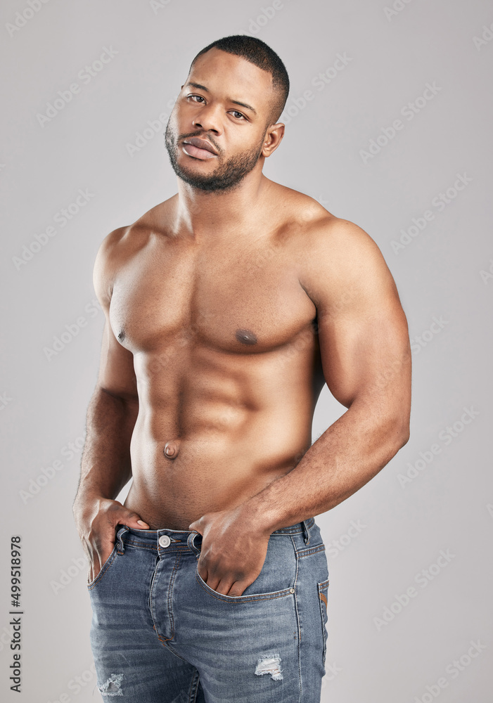 Stop doubting yourself. Work hard and make it happen. Studio shot of a young muscular man posing against a grey background. Stop doubting yourself. Work hard and make it happen. Studio shot of a young muscular man posing against a grey background.