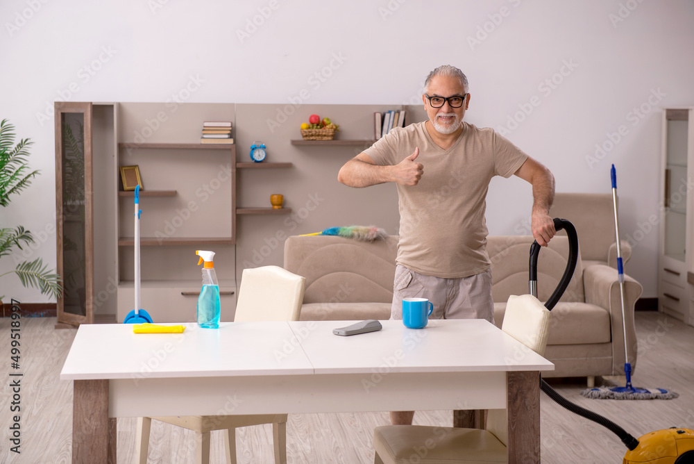 Old man doing housework at home Old man doing housework at home