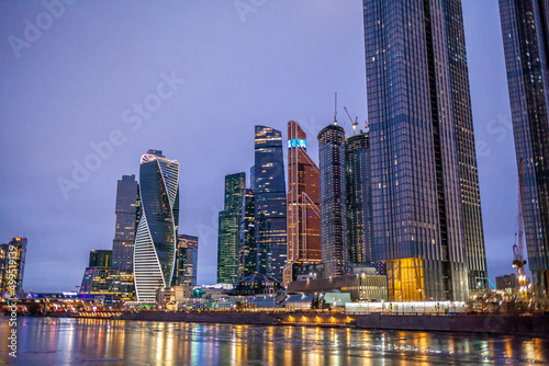 April 1, 2022, Moscow Russia. Moscow City International Business Centre skyscraper buildings with panoramic windows night view. Moscow City at night. Lights are reflected in the river.