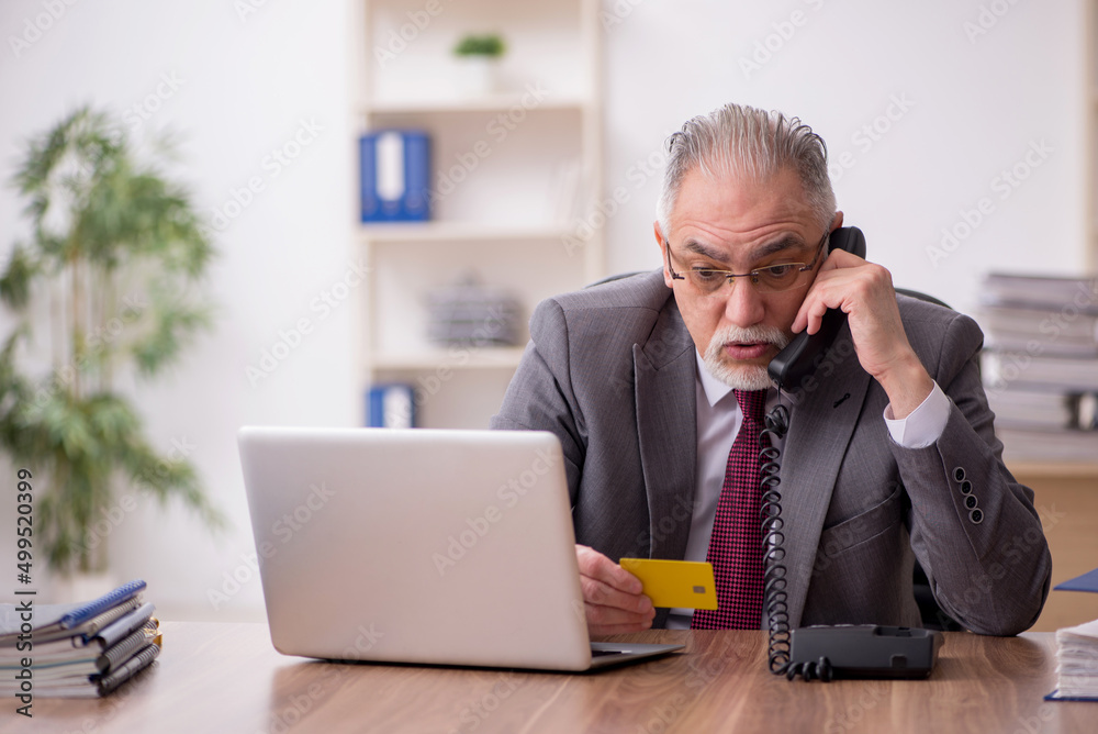 Old male employee in ecommerce concept Old male employee in ecommerce concept