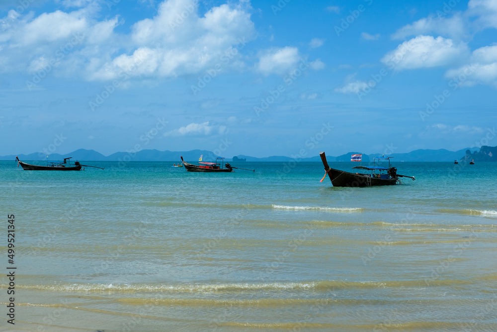 Longtail boats are mooring with the view of Koh Hong or Hong Island from Tubkaak Beach, Krabi, Thailand in the sunny day. One of Thailand's most famous luxurious beach. Longtail boats are mooring with the view of Koh Hong or Hong Island from Tubkaak Beach, Krabi, Thailand in the sunny day. One of Thailand's most famous luxurious beach.